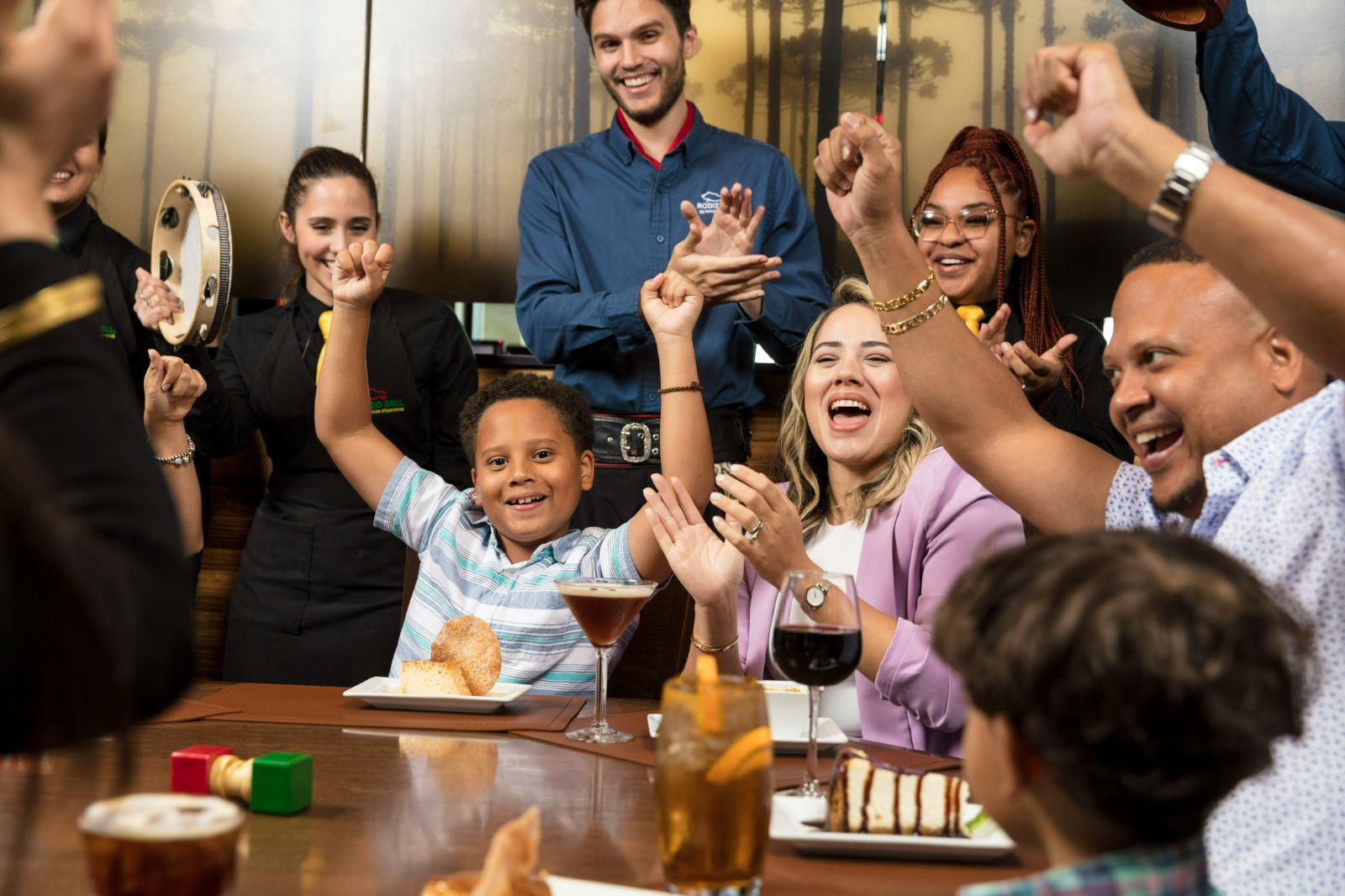Celebrate your BIRTHDAY with Rodizio Grill a group of people at a table with food