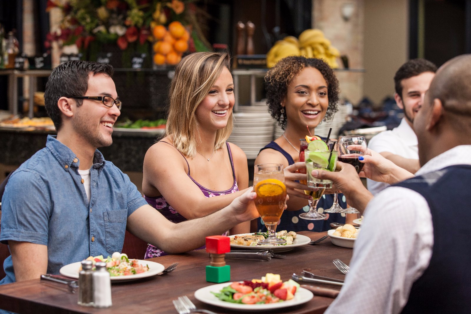 Fun at Rodizio Grill a group of people sitting at a table with food and drinks